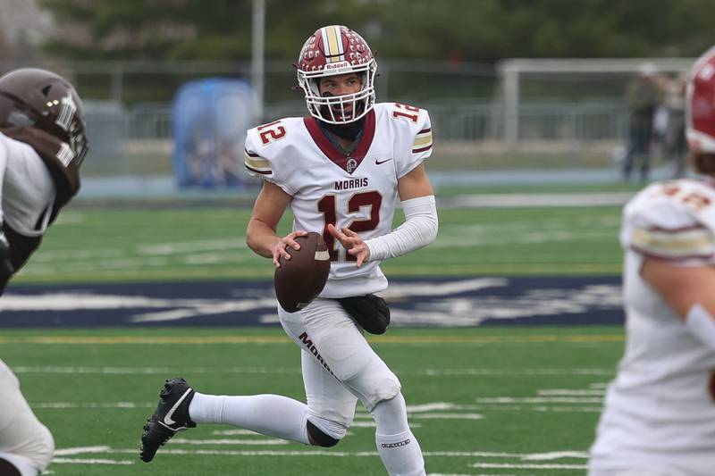 Morris’ Brady Varner rolls out to pass against Joliet Catholic in the Class 5A semifinal on Saturday, Nov. 23, 2024.