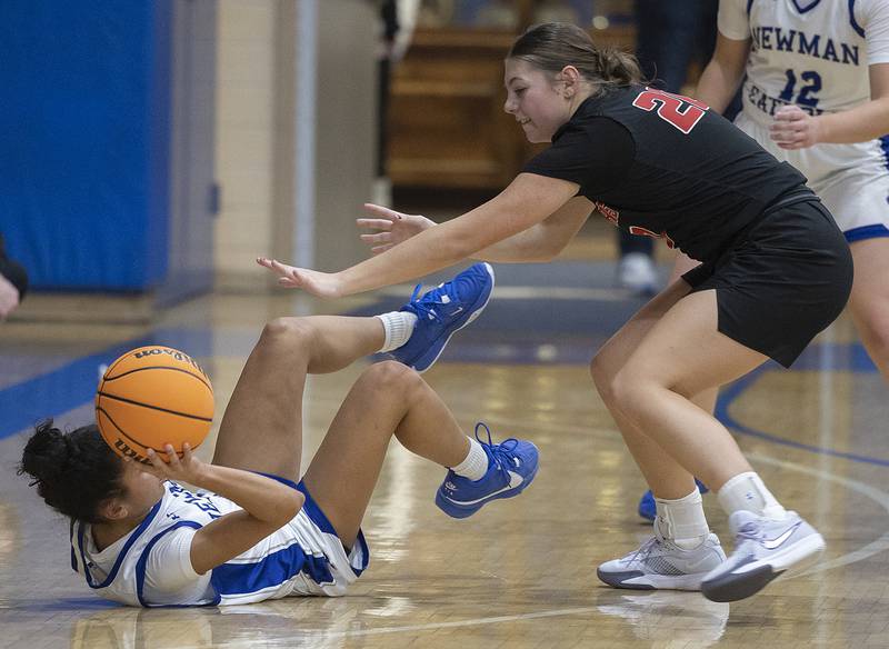 Newman’s Gisselle Martin makes a pass from her back as Erie-Prophetstown’s Izzy Johnson puts up defense Thursday, Dec. 12, 2024, at Newman High School.