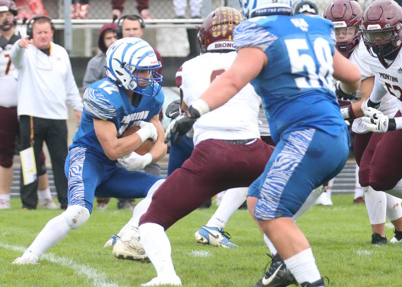 Princeton's Kaydin Gibson eyes an opening on a carry against Montini Catholic during the Class 3A quarterfinal game on Saturday, Nov. 16, 2024 at Bryant Field in Princeton.
