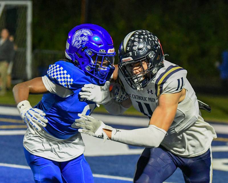IC Catholic Prep's Grant Bowen (11) gets defended by St. Francis's Javonte Williams (8) during the game on Friday Oct. 3, 2025, held at St. Francis High School.
