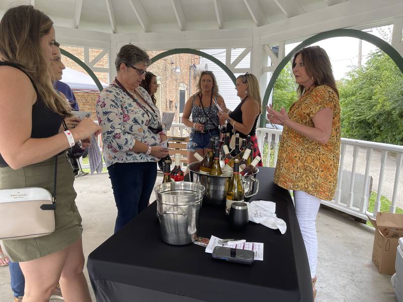 A group of people make a stop along a wine tour on Saturday, Sept. 17, 2022, in downtown Richmond. The wine-tasting was part of Richmond celebrating its 150th anniversary.