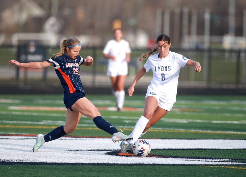 Lyons Township's Carolina Capizzi tries to keep the ball away from Naperville North's Alexa Surdyk during a game on Wednesday, April 16, 2025 in Naperville.