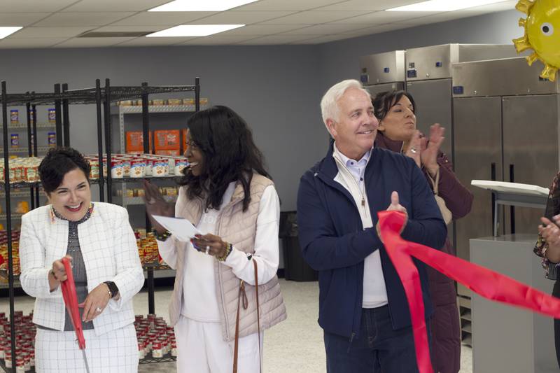 Joliet Township Supervisor Alicia Morales (left), cuts a red ribbon on Monday, April 21, 2025, for a ceremony recognizing the food pantry at the Joliet Township Forest Park Community Center. Standing next to Morales is Bettye Gavin, former executive director of the community center and Joliet City Council member, Joliet Mayor Terry D'Arcy, and Suzanna Ibarra, Joliet City Council member.