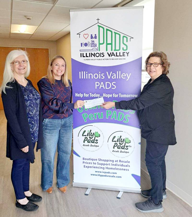 Presenting the $1,363 check to Illinois Valley Public Action to Deliver Shelter Executive Director Carol Alcorn (right) are Gail Pyszka, executive director and Beth Coleman, president of Illini Valley Association of Realtors.