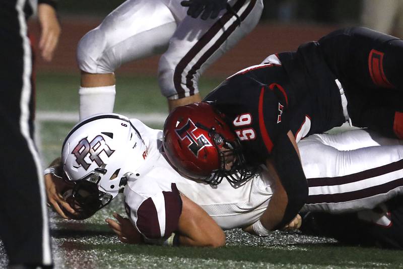 Prairie Ridge's Luke Vanderwiel tries to reach the ball into the end zone as he is tackled by Huntley's Ethan Albertson during a Fox Valley Conference football game on Friday, Sept. 20, 2024, at Huntley High School.