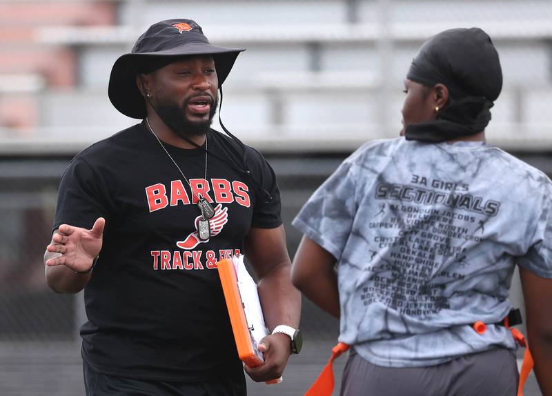 DeKalb head coach Cedric Little talks to quarterback Angela Gary Wednesday, Aug. 20, 2025, during the first practice of the DeKalb High School flag football team. The squad is preparing for their inaugural season.