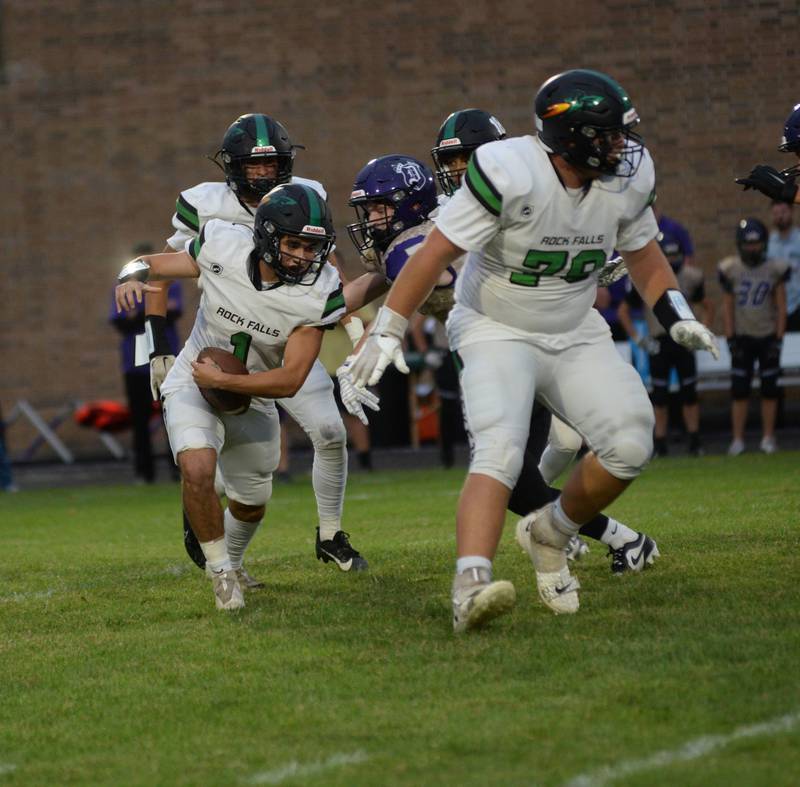 Rock Falls quarterback Easton Canales (1) looks for running room against the Dukes at AC Bowers Field on Friday, Sept. 9, 2023.