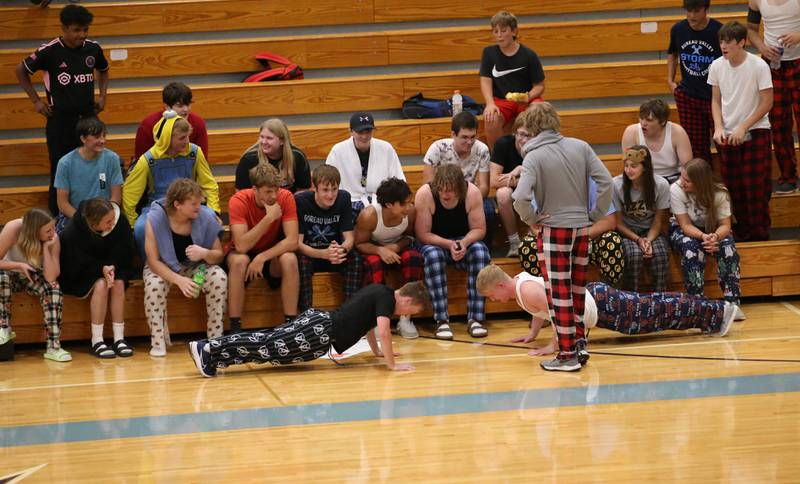 Bureau Valley super fans do pushups while wearing pajamas between sets of the volleyball game against St. Bede on Tuesday, Sept. 5, 2023 at Bureau Valley High School.