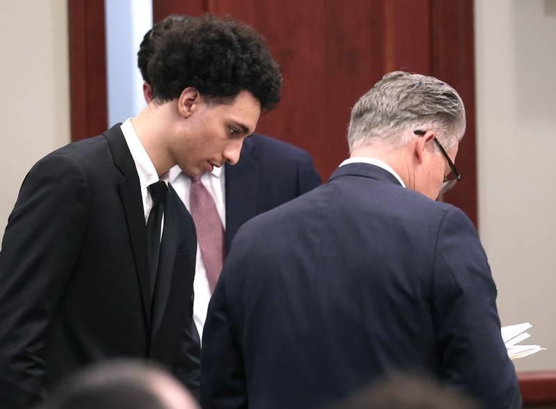 Hamza Khatatbeh, (left) 17, formerly of Sycamore, talks to Jim Ryan, one of his lawyers, Thursday, Feb. 19, 2026, during the second day of his murder trial at the DeKalb County Courthouse in Sycamore. Khatatbeh is accused of fatally stabbing Sycamore 17-year-old Kaleb McCall in 2023.