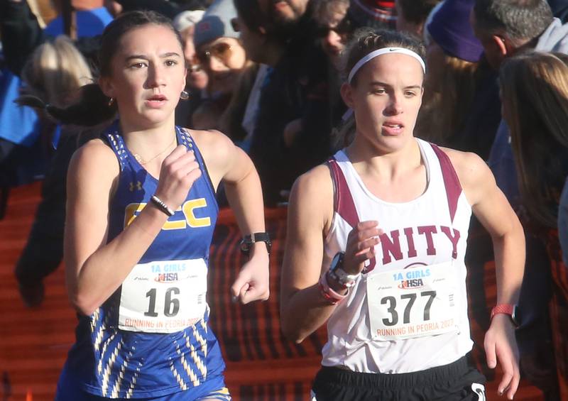 Aurora Central Catholic's Cecilia Hilby (left) competes in the Class 1A Cross Country Finals on Saturday, Nov. 4, 2023 at Detweiller Park in Peoria.