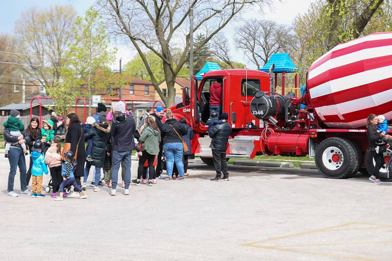 Parents stand in line with their children to enter a cement truck at the La Grange Touch a Truck event. April 22, 2023.