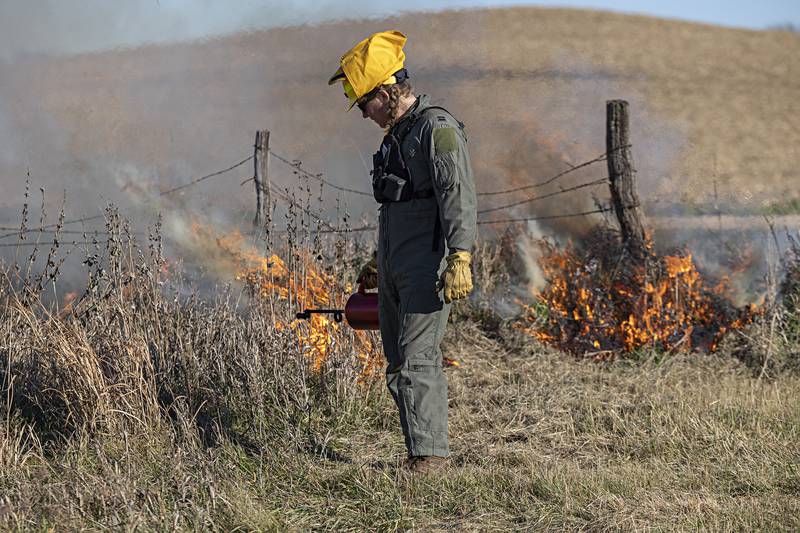 Jacob Churulo works after turning a corner on one edge of the prescribed burn Tuesday, Nov. 14, 2023.