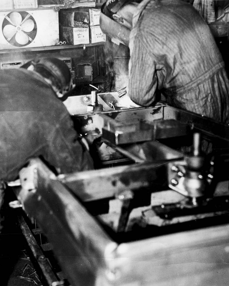 Welding of a main frame is underway in this Woods company archive photo.