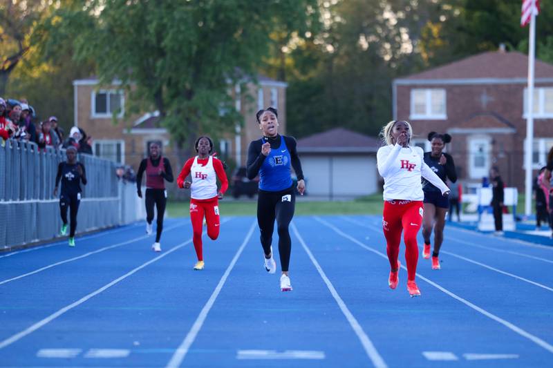 Lincoln-Way East's Alaina Steele, center, sprints alongside Homewood-Flossmoor's Mariyah Robinson in the 400-meter race during the IHSA Class 3A Chicago Heights Girls Track and Field Sectional at Bloom High School on Wednesday, May 13, 2026. Steele secured second place with a 56.42-second finish to qualify for state.