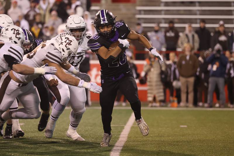 Downers Grove North’s Noah Battle rushes laterally against Mt. Carmel in the Class 7A championship on Saturday, Nov. 25, 2023 at Hancock Stadium in Normal.