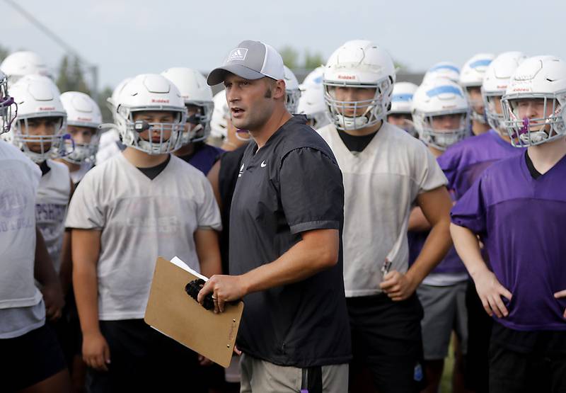 Hampshire football coach Shane Haak speaks to the team during the first day of football practice Monday, August 7, 2023, at Hampshire High School.