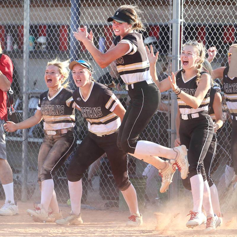 Sycamore players celebrate as the winning run crosses the plate in the bottom of the seventh during their Class 3A sectional championship game against Sterling Friday, June 2, 2023, at Belvidere North High School.