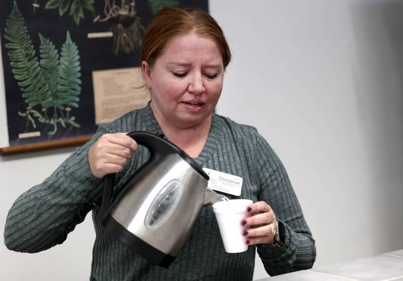 Dezaraé Haley, a U.S. Army veteran and owner of The Herbal Oracle in DeKalb, talks as she gets some tea Thursday, Oct. 10, 2024, at her shop in downtown DeKalb, about her experiences in the service and how her natural holistic living lifestyle has made her family happier and healthier.