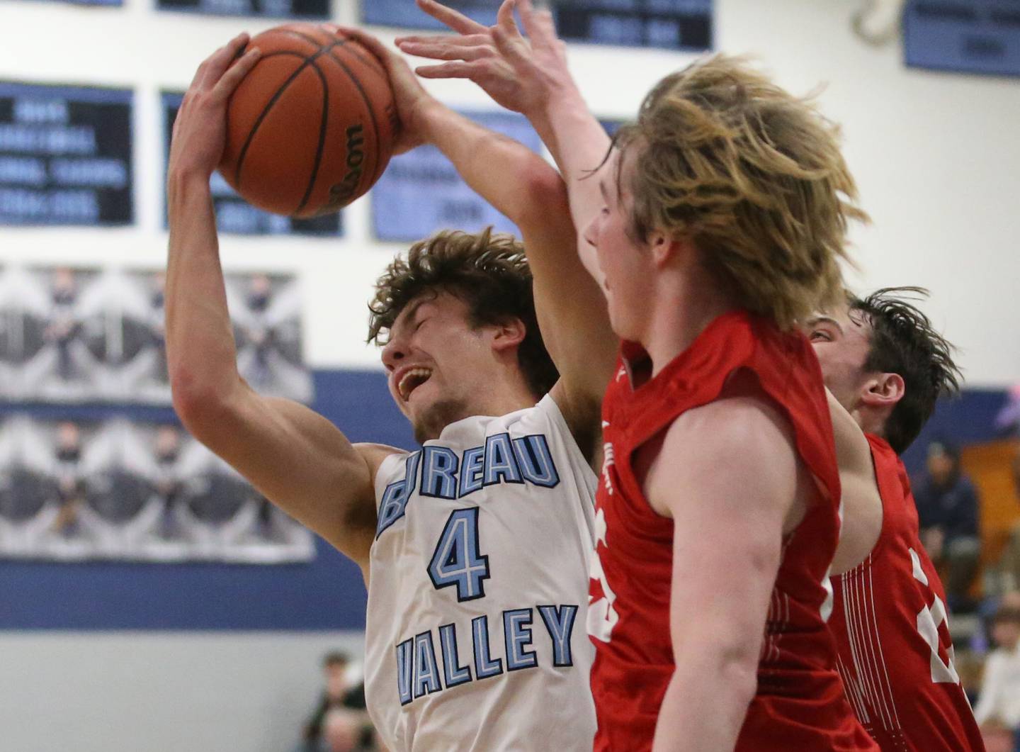 Bureau Valley's Landon Hulsing grabs a rebound over Hall's Wyatt West and Braden Curran on Friday, Jan. 19, 2024 at Bureau Valley High School.