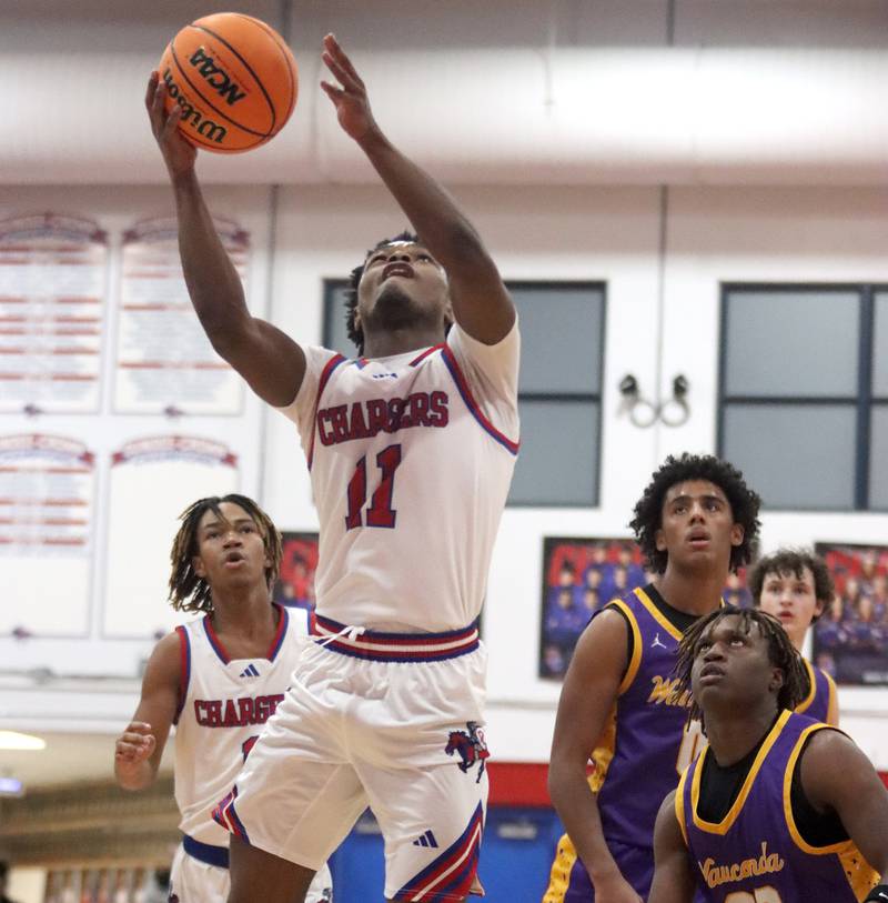 Dundee-Crown’s Terrion Spencer glides under the hoop against Wauconda in varsity basketball Friday, Dec. 20, 2024 at Dundee-Crown High School in Carpentersville.