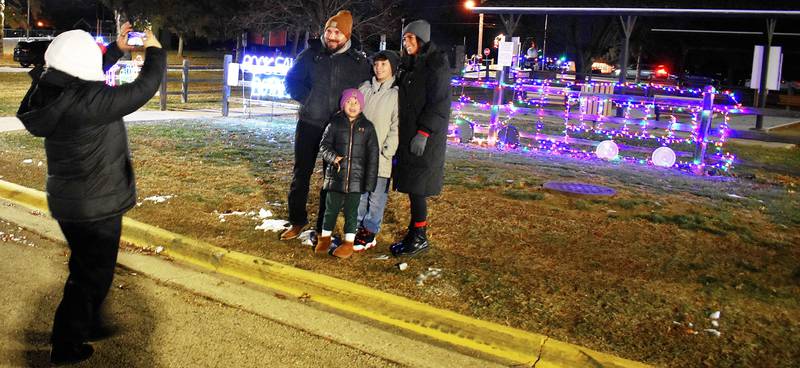 Shawn (left), Christina, Ronan, 9 and Remi Bahrs, 5, have their family photos taken after seeing Santa Friday, Dec. 19, 2025, in Rock Falls.