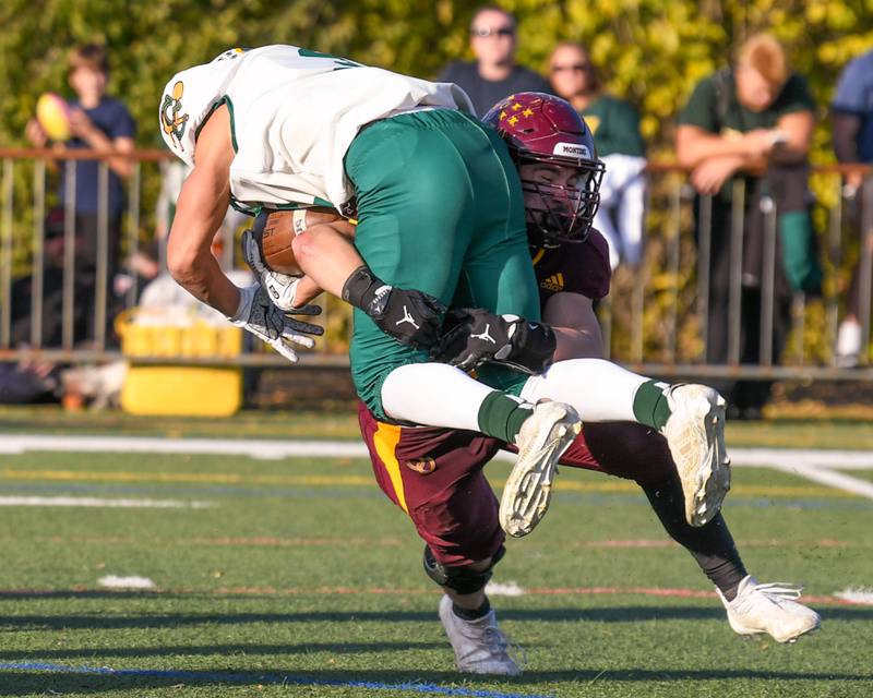 Coal City's ball carrier Brody Widlowski (3) was brought down by Montini Catholic's Laddie Asay (0) during the 4A quarterfinals game on Saturday Nov. 15, 2025, held at Montini Catholic High School.