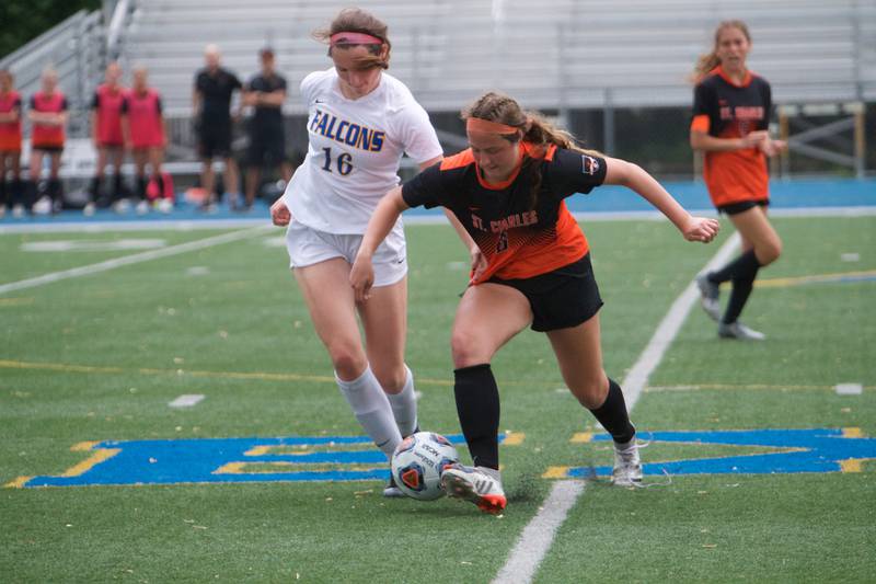 Wheaton North's Macy Hutchinson battles for the ball with St. Charles East's Mackenzie Loomis at the Class 3A Regional Final in Wheaton on May 20,2022.