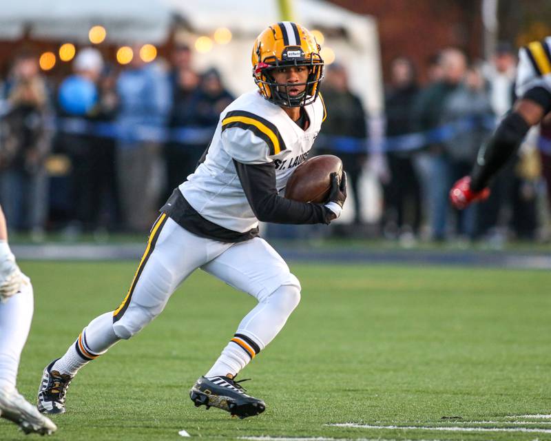 St Laurence's Vincent Enoch (1) runs with the ball after a catch during Class 4A third round playoff football game between St Laurence at IC Catholic Prep.  Nov 11, 2023.