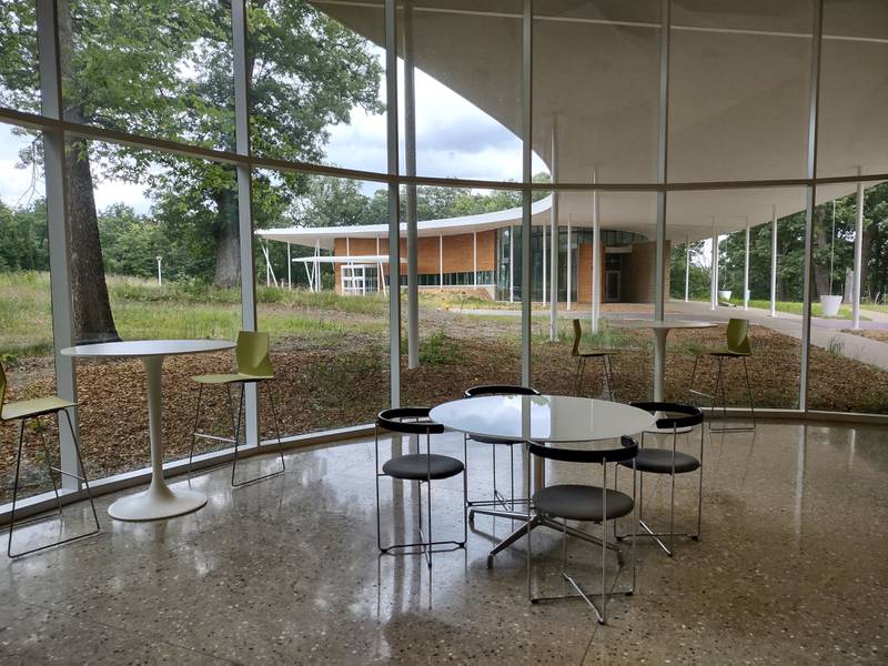 A kitchenette and seating area in the Health and Wellness Building at Nell's Woodland gives visitors a space to relax and view the grounds.