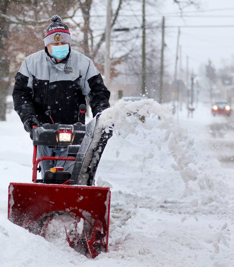 Ray Bober of Huntley uses a snowblower to clear his property on Tuesday, Jan. 26, 2021 in Huntley.