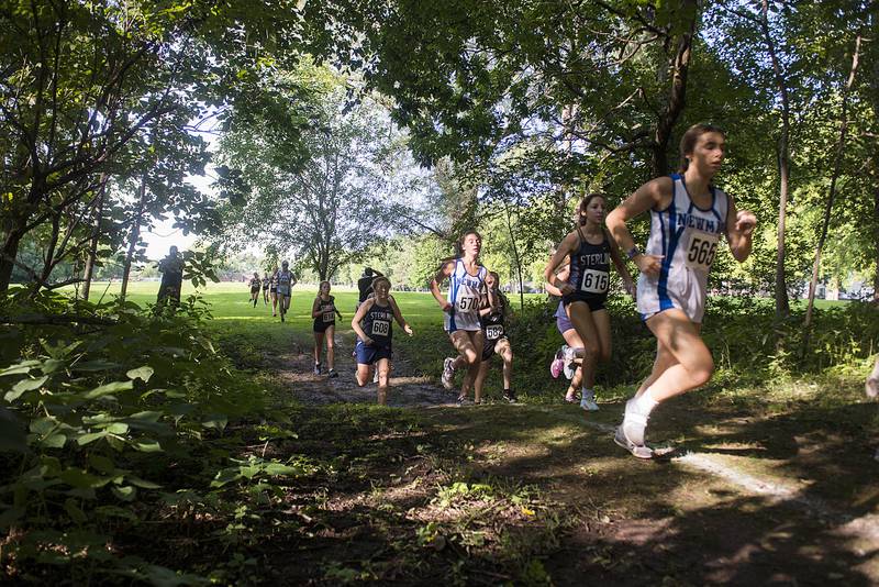 Racers enter the trail portion of the Twin Cities Cross Country Meet in Sterling, Sept. 13, 2022.