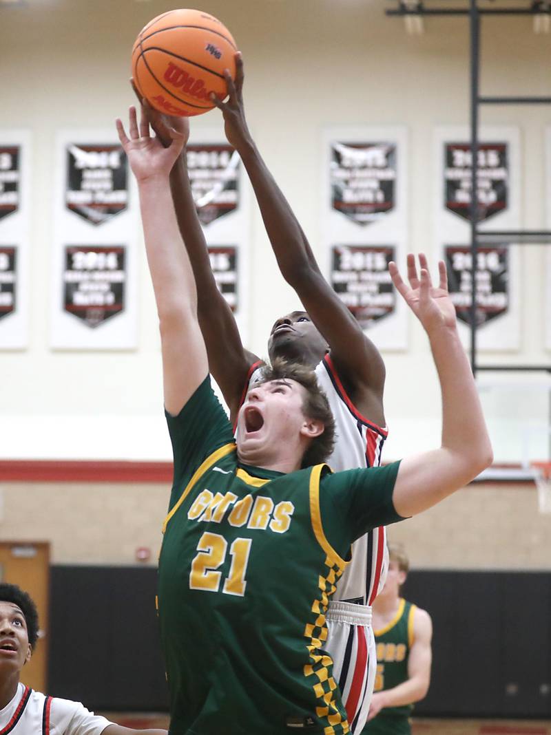 Huntley's Isaiah Onu grabs a rebound over Crystal Lake South's Ryan Morgan during a Fox Valley Conference boys basketball game on Wednesday, Dec. 10, 2025, at Huntley High School.