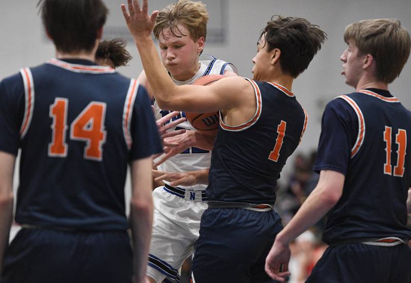 St. Charles North’s Parker Reinke fights for control of the ball against Naperville North in a boys basketball game in St. Charles on Wednesday, January 18, 2023.
