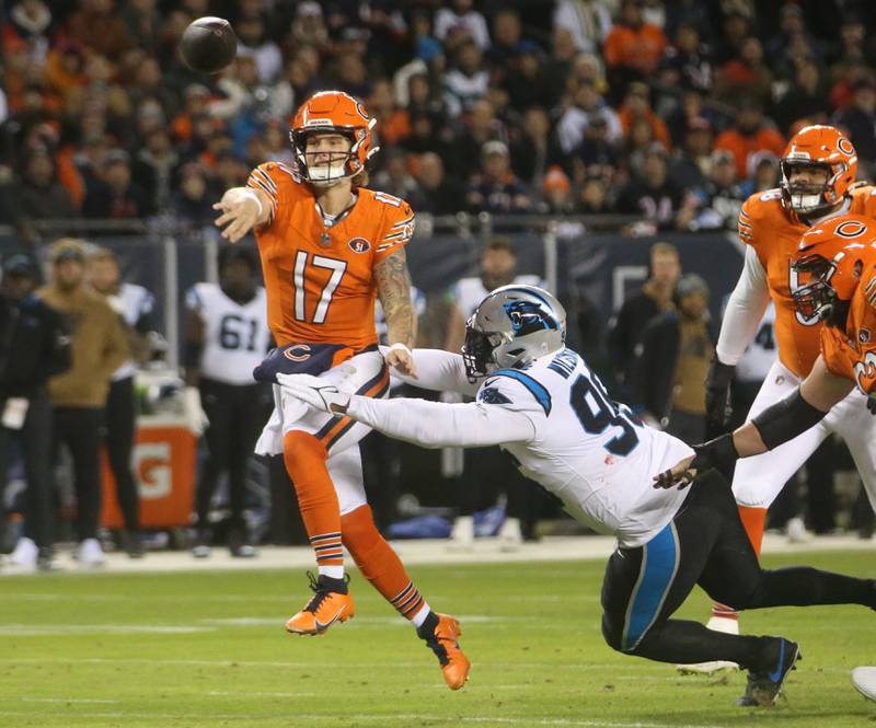 Chicago bears quarterback Tyson Bagent escapes a sack from Carolina Panthers defensive end Shy Tuttle on Thursday, Nov. 9, 2023 at Soldier Field.