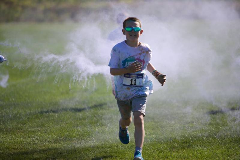 Kids run through the colors at the Glen Ellyn 2K Kids Color Bash Run on Saturday Aug.10, 2024 at Ackerman Park in Glen Ellyn.