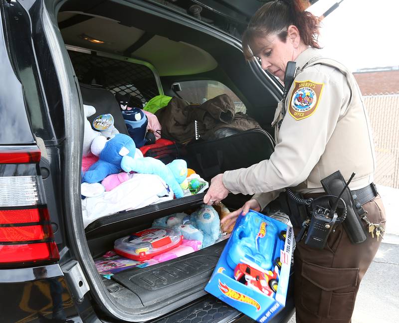 La Salle County Deputy Sheriff Felecia Rasmussen sorts through toys in the trunk of a squad car outside the La Salle County Government Complex on Tuesday, March 1, 2022 in Ottawa. Rasmuesen organized the Christmas 4 Kids toy drive for the past 18 years and plans to continue the event during her retirement.