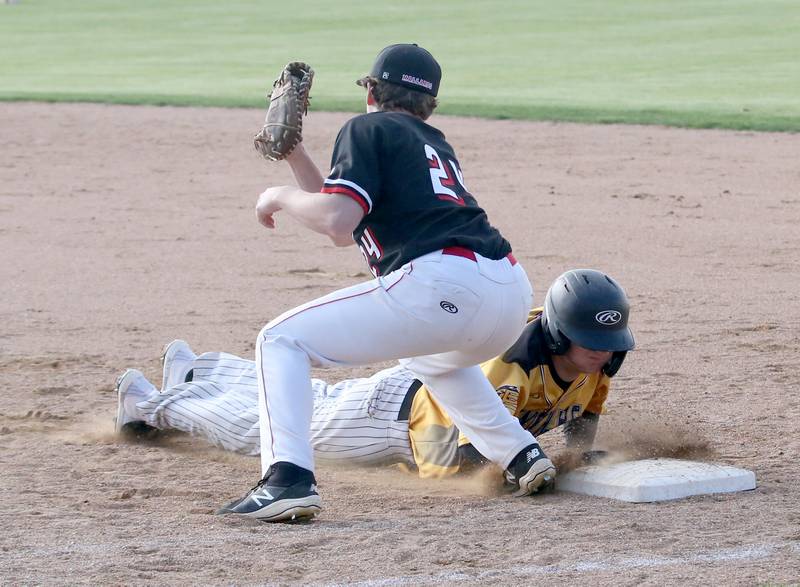 Henry-Senachwine's Mason Johnson misses a tag on Putnam County's Ryan Hundley after diving back into first base on Tuesday, April 25, 2023 at Putnam County High School.