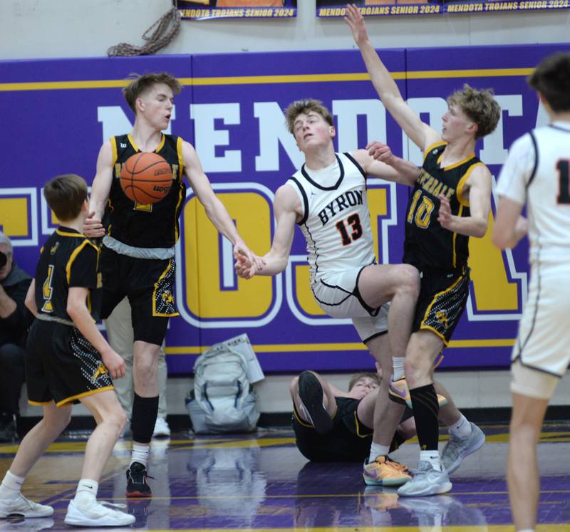 Byron's Jack Hiveley (13) and  Riverdale's Jake Willems (2) and Brody Clark (10) battle for the ball at the 2A Mendota Sectional on Wednesday, Feb. 28, 2024 at Mendota High School.