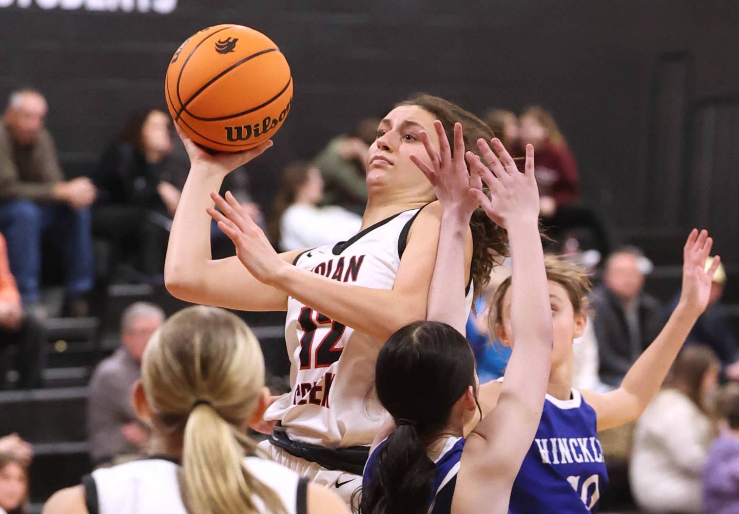 Indian Creek's Isabella Turner drives between two Hinckley-Big Rock defenders during their game Monday, Jan. 13, 2025, at Indian Creek High School in Shabbona.
