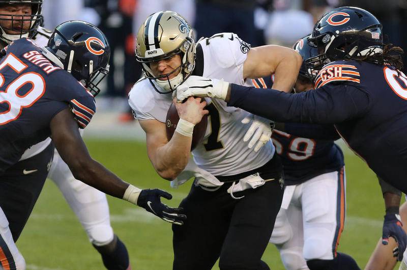 Chicago Bears linebacker Roquan Smith and defensive tackle John Jenkins converge on Saints quarterback Taysom Hill Sunday during the game at Soldier Field in Chicago.