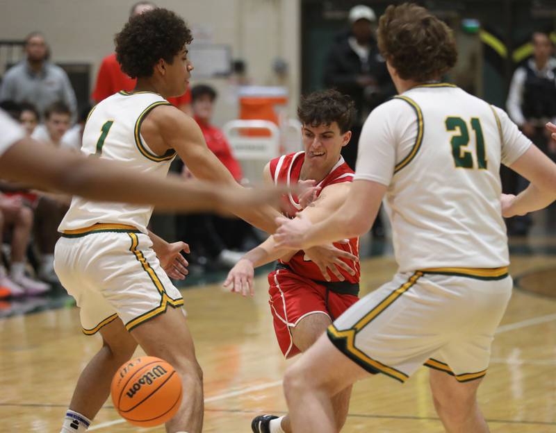 Huntley's Casey Kaczmarski (center) tries to pass the ball between Crystal Lake South's Noah Cook( left) and Ryan Morgan (right) during a Fox Valley Conference boys basketball game on Friday, Jan. 30, 2026, at Crystal Lake South High School.