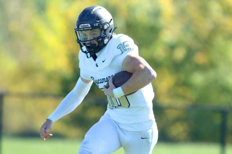 Sycamore’s Burke Gautcher runs the ball against Woodstock North in varsity football in Woodstock Saturday.