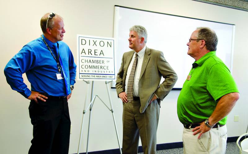David Hellmich (center), the sixth president of Sauk Valley Community College, speaks with Sinnissippi Centers CEO Patrick Phelan (left) and John Thompson, president of the Dixon Area Chamber of Commerce, on Wednesday afternoon during a meet and greet at KSB Town Square.
