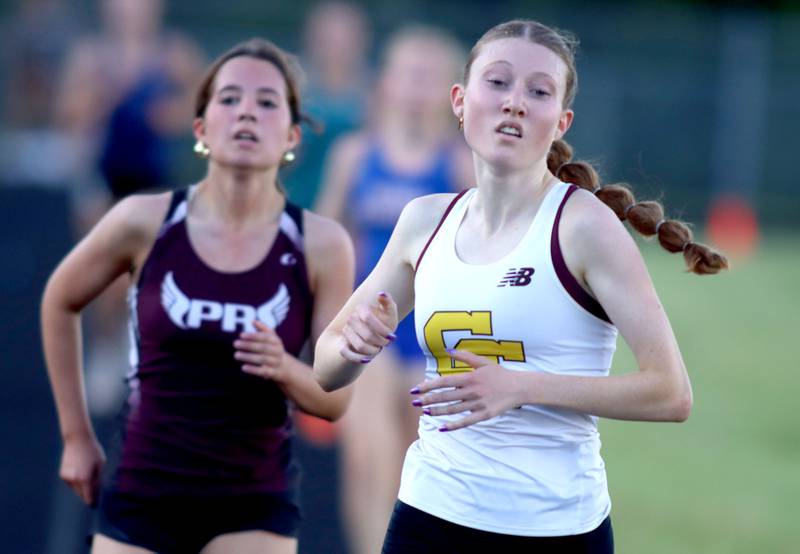 Carmel’s Izzy Bing, right, edges out Prairie Ridge’s Emaline Foster at the finish of the 3200-meter run in IHSA Class 2A Girls Sectional Track action at Genoa-Kingston School in Genoa on Friday, May 16, 2025.
