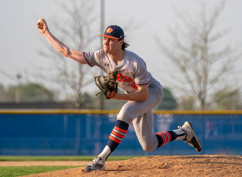 Oswego’s Andrew Hart (10) delivers a pitch against Oswego East during a baseball game at Oswego East High School on Tuesday, May 10, 2022.