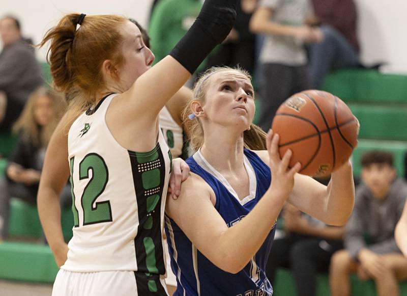Newman’s Jess Johns looks to put up a shot while being guarded by Rock Falls’ Emily Lego Thursday, Nov.17, 2022.