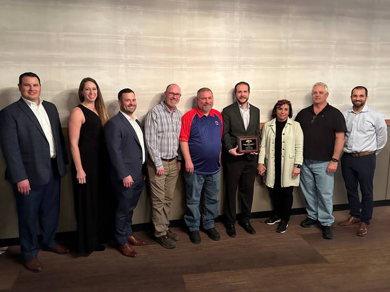 Left to right:  Leo Morand (GHA/APWA Awards Chair), Susan Novak (Lake County Stormwater Management Commission), Andrew Puccini (Trotter & Associates), Trent Turner (Village of Fox Lake), Dan Guinn (Village of Fox Lake), Kealan Noonan (Village of Fox Lake), Deb Waszak (Administrator, Village of Fox Lake), Donny Schmit (Mayor, Village of Fox Lake), and Kyle Johnson (APWA, Lake Branch President) pose for a group photo after accepting the project of the year award at the Jan. 17 luncheon in Libertyville.