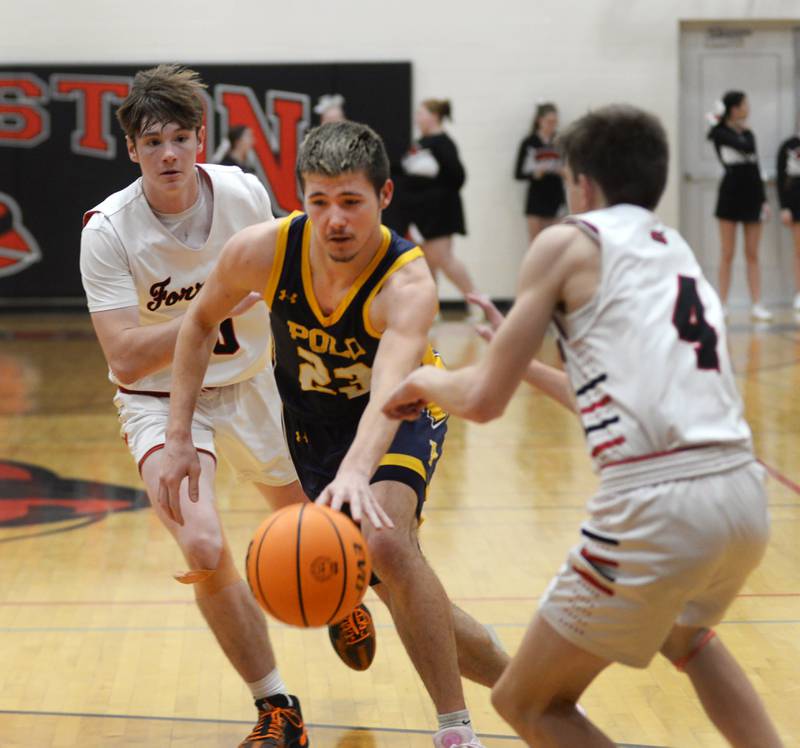 Polo's Noah Dewey (center) fights for the ball between Forreston's Brendan Greenfield (left) and Brady Gill (right) on Tuesday, Jan. 7, 2024 at Forreston High School.