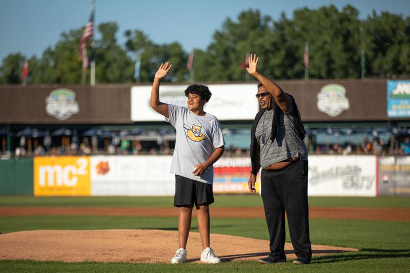 Ben Shipley (15) and Leslie David Baker wave to fans before the first pitch at Northwestern Medicine Field on Thursday, July 14, 2022. Leslie David Baker played the character Stanley Hudson on the television show "The Office."