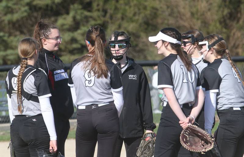 Woodland head softball coach Sydnee Plesko talks to her team on the mound while playing St. Bede on Tuesday, April 8, 2025 at Woodland High School.